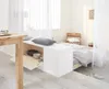 A bedroom with a bed and a dining table, separated by a white storage unit. Anteprima dell’immagine prodotto