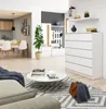 A modern living room with a chest of drawers, a coffee table, and a sofa in the foreground. Podgląd zdjęcia produktu