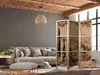 A living room with a sofa, ottoman, and a folding screen. Náhled obrázku produktu