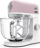 A close-up studio shot of a pink and white Kenwood Kmix stand mixer. Voir les images du produit