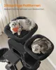 Two cats are resting on a dark gray cat tree with plush platforms. The background is a room with soft lighting. Produktbild-Vorschau