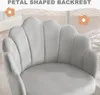 A close-up of a light gray velvet chair with a petal-shaped backrest, with decorative flowers and text overlay. Produktbild-Vorschau