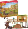 A toy playset of a wildlife adventure station, including a treehouse, animals, and figures, shown both in its packaging and assembled. Anteprima dell’immagine prodotto