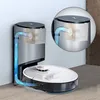 A robotic vacuum cleaner docked at its charging station, with an inset showing a diagram of the airflow. Náhled obrázku produktu