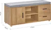 A shoe cabinet with a cushioned top, featuring a door on the left and shelves and drawers on the right. Dimensions are indicated by lines and text. Produktbild-Vorschau
