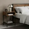 A bedside table next to a bed. Náhled obrázku produktu