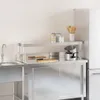 A stainless steel shelf unit with kitchen items on it, next to a sink and refrigerator. Anteprima dell’immagine prodotto