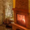 A cozy living room scene with a fireplace and a decorative Christmas tree. Náhled obrázku produktu