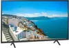 A television displaying a scenic view of a coastal town. Náhled obrázku produktu