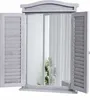 A mirror designed to look like a window with shutters, set against a white background. Náhled obrázku produktu