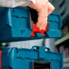 A hand is shown connecting two blue storage boxes. Podgląd zdjęcia produktu