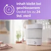 A baby bottle sterilizer and dryer is shown on a wooden table with a blurred background of a room. Produktbild-Vorschau