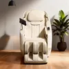 A cream-colored massage chair is shown in a well-lit room with a plant and a hanging lamp. Produktbild-Vorschau