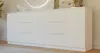 A white sideboard with drawers and doors, placed in a room with a rug and a mirror in the background. Náhľad obrázku produktu