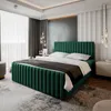 A bedroom with a green upholstered bed as the main focus. Produktbild-Vorschau
