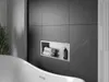A modern bathroom with a bathtub and a tiled wall featuring a built-in shelf. Náhled obrázku produktu