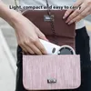 A person is placing a white handheld fan into a pink purse. Náhled obrázku produktu