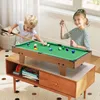 Two children playing with a mini billiard table on a wooden stand. Produktbild-Vorschau