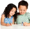 Two children are playing with small toy figures on a white table. Voir les images du produit