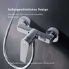 A close-up shot of a chrome shower faucet mounted on a textured gray wall. Produktbild-Vorschau