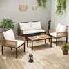 An outdoor patio set with a sofa, two chairs, and a coffee table, set on a wooden deck with plants and hanging lights. Anteprima dell’immagine prodotto