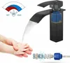 A black waterfall faucet with water flowing into hands, and diagrams of hot/cold indicators and internal components. Produktbild-Vorschau