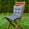 A gray cushion on a wooden chair in a garden. Podgląd zdjęcia produktu