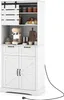 A white kitchen cabinet with sliding barn doors on top, a coffee maker, and jars on shelves. The cabinet has two drawers and two doors at the bottom, with a black power cord extending from the right side. Podgląd zdjęcia produktu