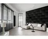 A modern living room with a sectional sofa, a textured dark gray wall, and large windows with blinds. Anteprima dell’immagine prodotto