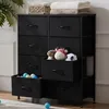 A black fabric dresser with eight drawers, some of which are open, revealing toys and balls. Voir les images du produit