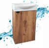 A bathroom vanity with a sink and a wooden cabinet, with water splashes around it. Podgląd zdjęcia produktu