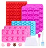 A collection of silicone molds for baking dog treats, along with a few sample treats and baking accessories. Produktbild-Vorschau