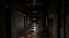 A dark, grimy, and wet corridor with pipes and graffiti on the walls. Podgląd zdjęcia produktu
