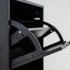 A close-up view of the interior mechanism of a black shoe cabinet. Náhľad obrázku produktu