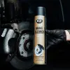 A gloved hand holds a can of brake cleaner next to a car's brake assembly. Produktbild-Vorschau