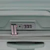 A close-up view of the combination lock and zippers on a green suitcase. Anteprima dell’immagine prodotto