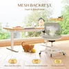 A child's desk chair and adjustable desk are set up in a bright room with a large window overlooking a garden. An orange cat is playing with a yellow ball on the floor. Produktbild-Vorschau