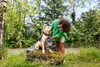 A person is drying a dog with a towel outdoors. Produktbild-Vorschau
