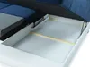 A close-up view of the storage compartment of a sofa, with the mattress lifted to reveal the empty space underneath. Náhľad obrázku produktu