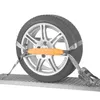 A car wheel secured with a strap on a metal platform. Produktbild-Vorschau