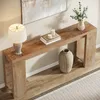 A console table with a lamp, books, candles, and a vase. Produktbild-Vorschau
