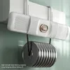 A white air conditioner deflector is mounted on a wall, with a heavy stack of metal weights hanging from it to demonstrate its load-bearing capacity. Náhľad obrázku produktu