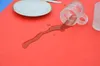 A spilled drink on a red surface with a plate and a mug. Produktbild-Vorschau