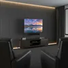A home theater setup with two leather chairs facing a wall-mounted TV. Podgląd zdjęcia produktu