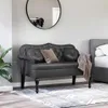 A tufted Chesterfield bench is placed in a bedroom setting next to a bed, with a large round mirror on the wall behind it. Náhľad obrázku produktu