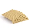 A stack of beige LEGO baseplates on a white background. Produktbild-Vorschau