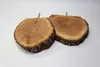 Two wooden discs with bark edges, each with a metal screw protruding from the top, are displayed on a white background. Produktbild-Vorschau