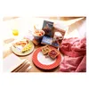 A breakfast spread with books and a blanket. Produktbild-Vorschau