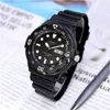 A black Casio watch is placed on a newspaper with a pen nearby. Voir les images du produit