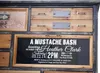 A vintage-style apothecary cabinet with a chalkboard-style invitation displayed on one of the drawers. Podgląd zdjęcia produktu